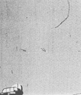 Frame print from the Mariana film showing two disk-like objects