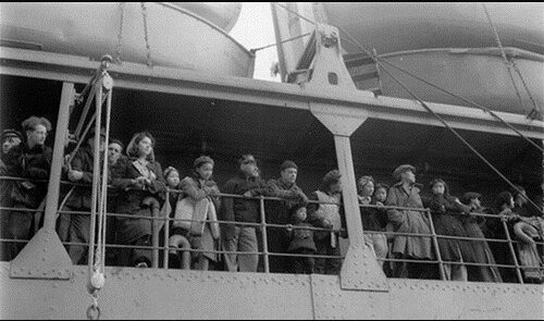 Evacuees gaze at their homes as USAT Delarof pulls away from the dock, St. Paul Island, 1942